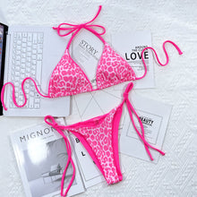 hot pink leopard print halter neck tie side bikini set back flat lay view with sophistacated background