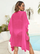 Back view of hot pink ruffled open-front beach cover-up showing relaxed fit and lightweight, flowing fabric