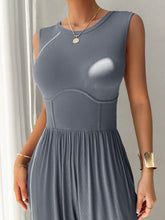 A model posing in the Blue-Gray color Devine Round Neck Sleeveless Wide Leg Jumpsuit paired with gold jewelry