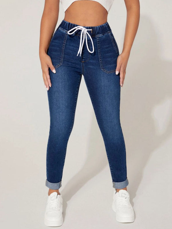A model wearing the Kavoya DriftFlex Elastic Waistband & Drawstring Cropped Denim Pants paired with a  white blouse and white sneakers.