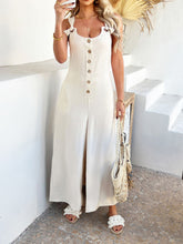 Model styled in beige Kélure Stunner with gold earrings and nude heels.