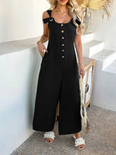 Close-up of textured black fabric and polished gold buttons.