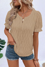 Model wearing Khaki Wavelle Blouse paired with distressed denim shorts and accessories.