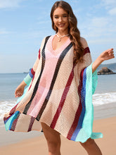 Model wearing royal blue openwork color block plunge cover-up with deep V-neckline at beachside setting