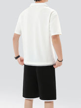 Back view of solid white Kyven CrestFlex set featuring short sleeve top and relaxed fit shorts on model.