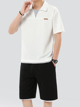 Man wearing solid white Johnny collar top and shorts set, front view standing.