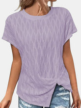 A woman shopping in Los Angeles wearing the Lavender Ruched Wavy Pattern Round Neck Short Sleeve T-Shirt paired with distressed denim shorts, jewelry, and heels.