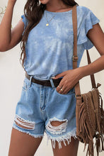 Model styling light blue Printed Blouse tucked into high-rise trousers