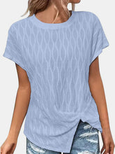 A woman shopping in Paris wearing the  light blue Ruched Wavy Pattern Round Neck Short Sleeve T-Shirt paired with distressed denim shorts, jewelry, and heels.