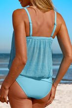 Light blue Marévia square neck tankini swim set back view pose by the beach