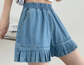 Plus size model in light blue wide leg ruffle jean shorts styled with crossbody bag.