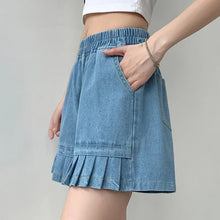 Side view of light blue plus size denim shorts featuring pocket and hem detail.