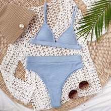 Front flat lay of light blue spaghetti strap ribbed bikini set displayed on hanger with adjustable straps