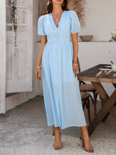Side profile of light blue Velunira dress showing textured fabric and fit.