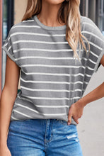 Model wearing  striped knit round neck short sleeve top, front view in light gray and white stripes, paired with denim jeans.