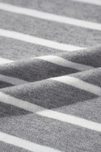 Close-up of light gray soft striped knit fabric quality.  