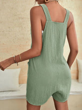 Light green romper rear angle highlighting airy fit and feminine tie straps.