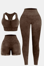 Flat lay of dark brown LineaFlow Vitality set: square-neck top, bra, and high-waist pants.