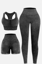 Flat lay of dark gray LineaFlow Vitality set: square-neck top, bra, and high-waist pants.