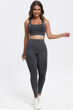 Model in dark gray LineaFlow Vitality set, front view highlighting square-neck crop top, wide‑strap bra, and high-waist pants.
