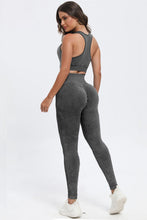 Rear view of woman lounging in dark gray LineaFlow Vitality set.
