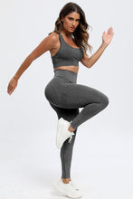 Side stretch pose in dark gray LineaFlow Vitality set showcasing flexibility and fit.