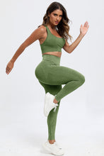 Side stretch pose in moss LineaFlow Vitality set showcasing flexibility and fit.