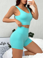Woman lounging on bed in Mint Blue LumiCore BreezeActive set, taking a mirror selfie.