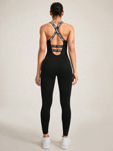 Back view showing crisscross strap detail on black LuminaCross Apex Jumpsuit.