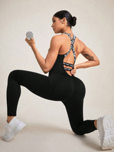 Woman in black LuminaCross Apex Jumpsuit performing backbend weight lift pose.