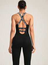Close-up of crisscross strap junction and fabric texture on black LuminaCross Apex Jumpsuit.