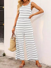 Side profile of a model in a Lunalvia Striped Round Neck Wide Leg Jumpsuit, capturing the drape of the wide-leg cut and flattering fit along the waistline.