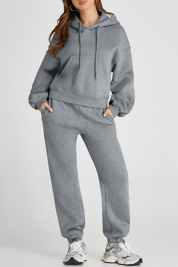 Model wearing gray Lunetta DriftSet, front view showcasing hooded top and relaxed-fit pants.
