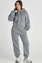 Side view of model stretching arm overhead while wearing gray Lunetta DriftSet.