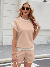 Model styled in apricot Lustressa™ Shorts Set with delicate chain necklace.