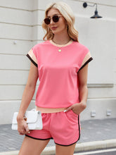 Model walking city streets in coral Lustressa™ Contrast Co-ord with white sneakers.