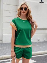 Model styled in green Lustressa™ Shorts Set paired with straw hat and sandals.