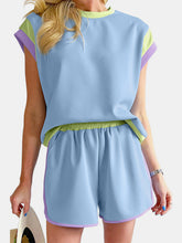 Close-up detail of vibrant colors, contrast trim neckline, and sleeve on Lustressa™ Set, in light blue
