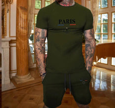 Close-up of deep forest green Luvéris Paris Crest Set showing 3D Paris print near grand piano.