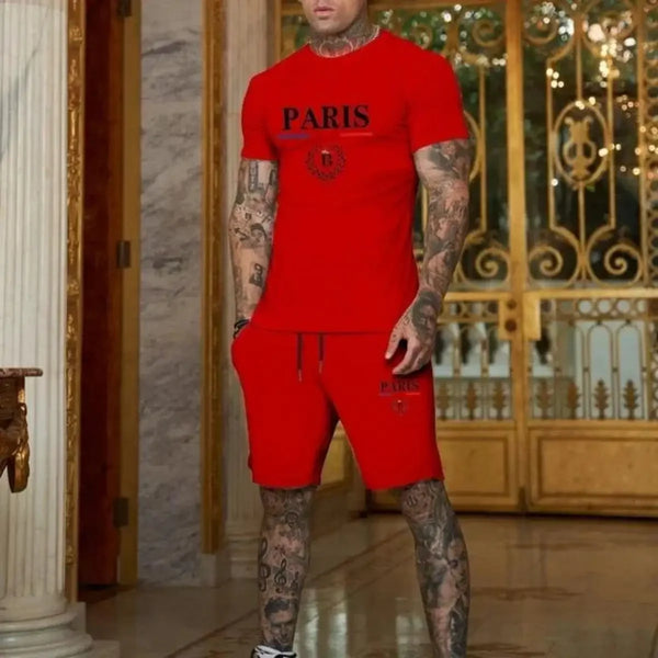 Man in red Luvéris Paris Crest Set with hand in pocket at mansion.