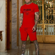 Man in red Luvéris Paris Crest Set with hand in pocket at mansion.