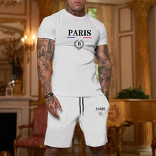 Person wearing a white Luvéris Paris Crest Set with a hand in pocket in an elegant room.