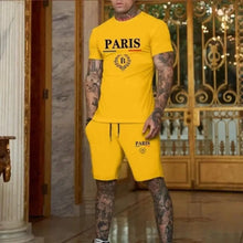 Person wearing a yellow Luvéris Paris Crest Set with one hand in pocket in an elegant interior setting.