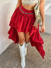 Model walking forward in Lyvérielle Cascade Skirt deep red, showing layered high-low flowy motion