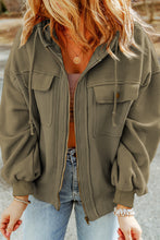 Model in matcha green Nivora™ DriftZip Hoodie shown from the side, featuring zip-up front, side pockets, and soft drape.