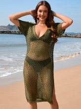 Model smiling wearing matcha green slit openwork Johnny collar short sleeve cover-up dress with side slit detail at the beach