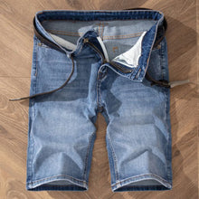 Men's medium blue vintage wash stretch denim bermuda shorts front view.