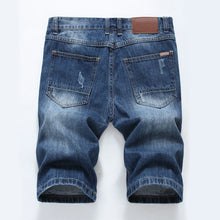 Back view showing rear pockets and slim fit of men's medium blue denim shorts.