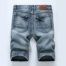 Back view showing rear pockets and slim fit of men's vintage blue denim shorts.