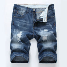 Front view of men's medium blue slim fit light washed distressed denim shorts.